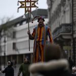 Stilt walker in costume at Vilnius street festival, capturing urban celebrations.