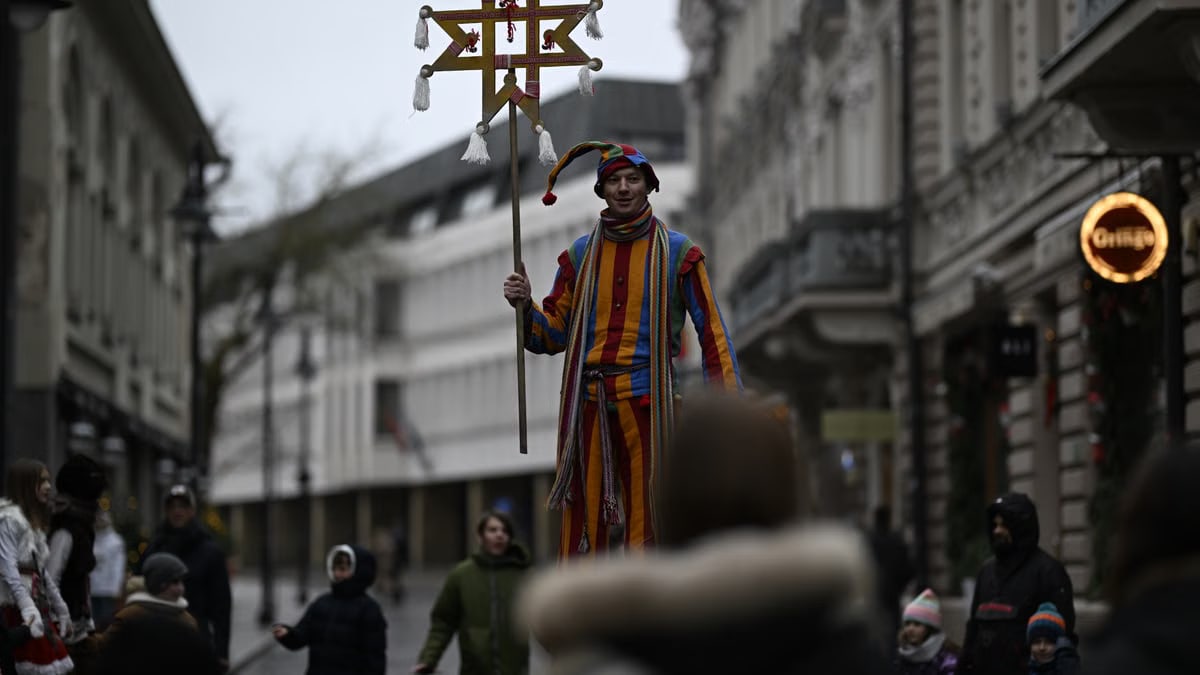 Stilt walker in costume at Vilnius street festival, capturing urban celebrations.